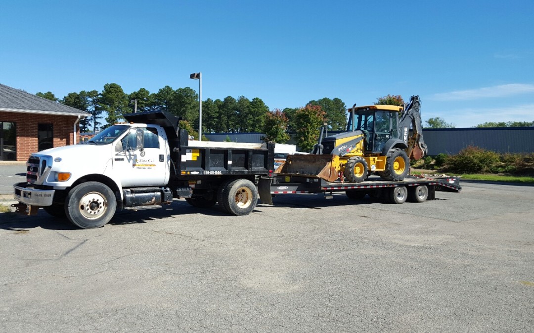 Firstcall Environmental Dump Truck with Backoe