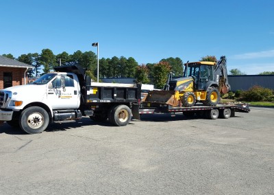 Firstcall Environmental Dump Truck with Backoe